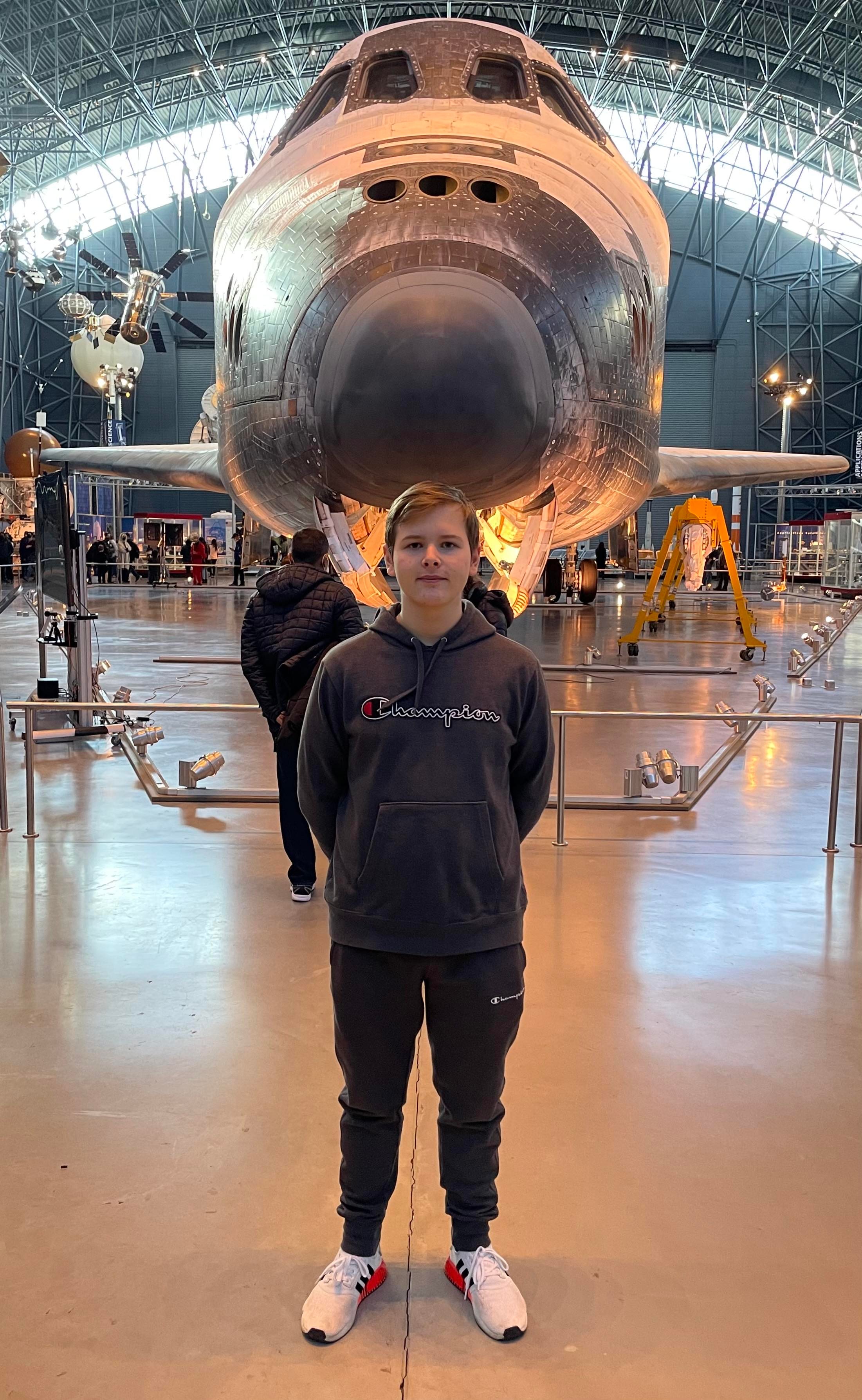 peter standing in front of space shuttle